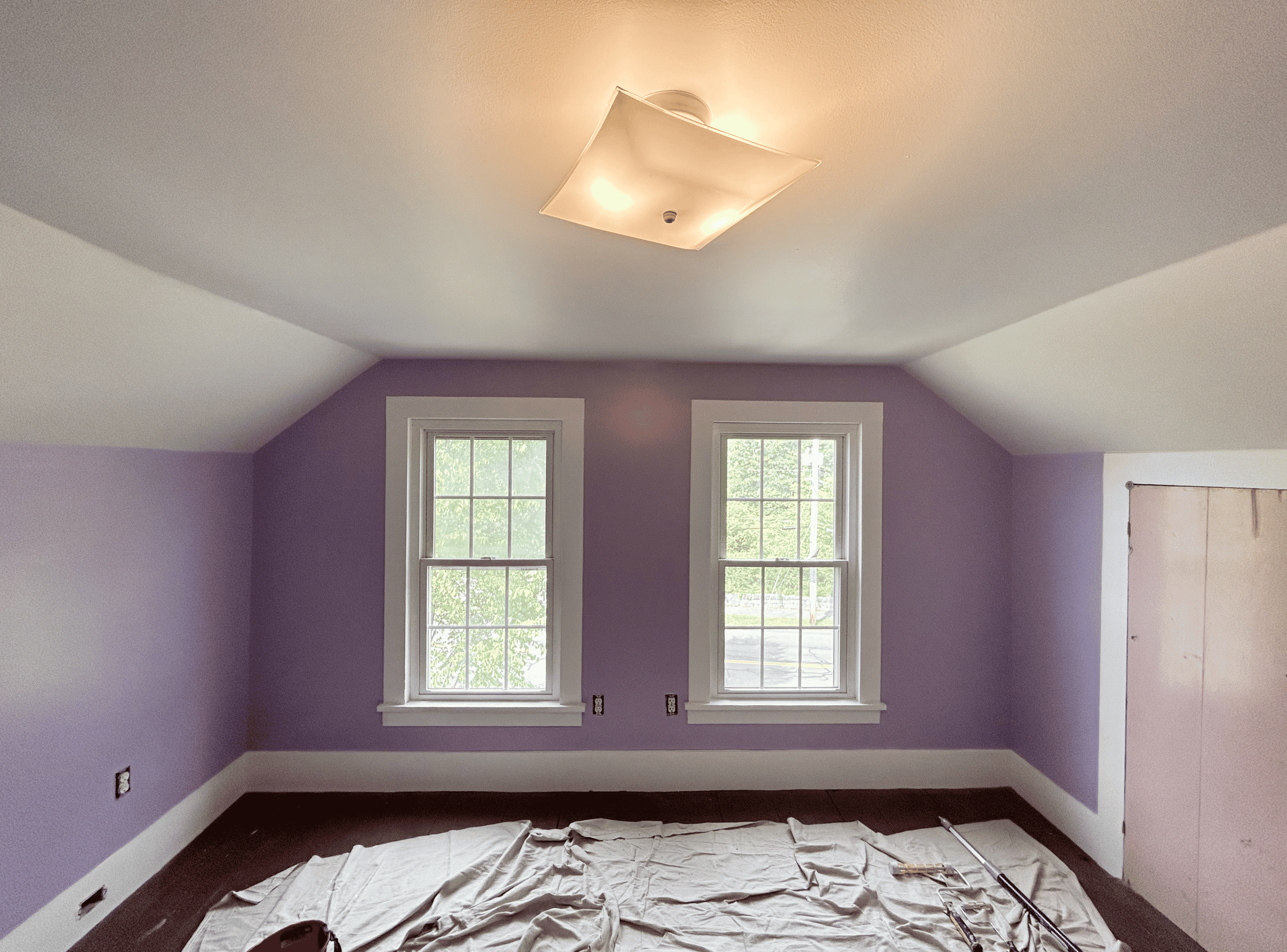 Cozy Purple Bedroom Bright purple bedroom with two windows and fresh paint. Perfect space for relaxation and comfort.